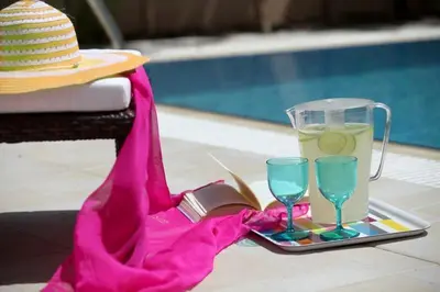 a table with a hat and a book and glasses at Michelle 8 in Protaras