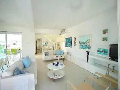 a living room with a couch and a table at Architect's Villa in Protaras