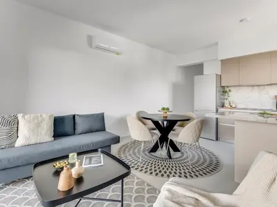 a living room with a couch and a table at Sanders Triple in Limassol