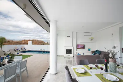 a dining room and living room with a pool at Villa Prol24,brand New 2bdr Protaras Villa with Pool,close to Fig Tree Bay Beach in Protaras