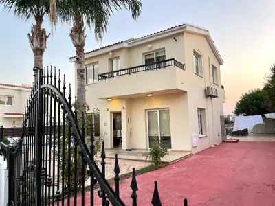 a house with a gate and palm trees at Sunset Pearl Holiday Villa in Ayia Napa