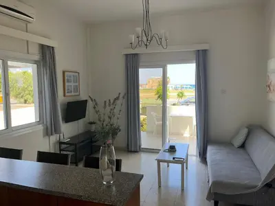 a living room with a couch and a table at Themis Beach Apartments in Larnaka