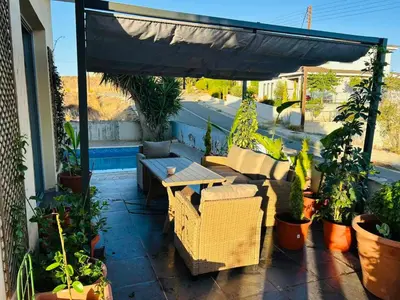 a patio with a table and chairs and potted plants at Impeccable 3-Bed Villa in Nicosia in Yukarı Lakatamya