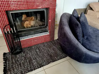 two blue chairs sitting next to a fireplace at Impeccable 3-Bed Villa in Nicosia in Yukarı Lakatamya
