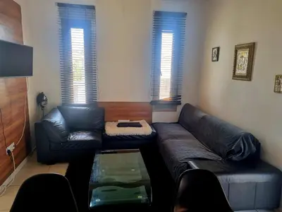 a living room with a couch and a table at Impeccable 3-Bed Villa in Nicosia in Yukarı Lakatamya