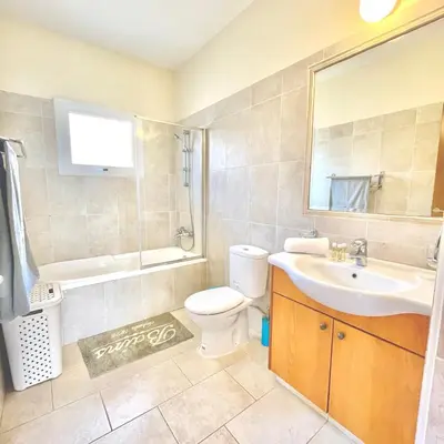 a bathroom with a sink and a toilet and a mirror at Mediterranean Breeze Villa in Protaras