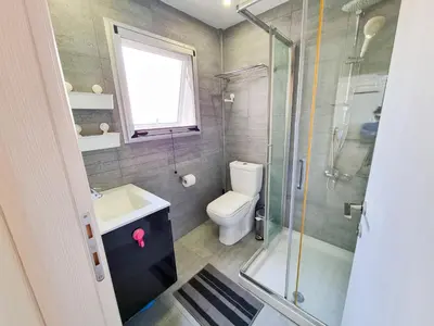 a bathroom with a toilet and a sink and a shower at Seaside Elegance Retreat in Larnaka
