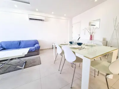 a living room with a table and chairs and a couch at Seaside Elegance Retreat in Larnaka