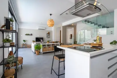 a kitchen with a counter and a living room at Villa Flora's 3-BR Retreat & Private Pool in Protaras in Paralimni