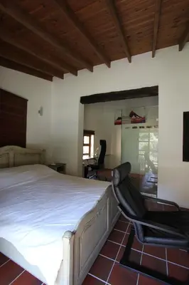 a bedroom with a bed and a chair at River House in Kakopetria