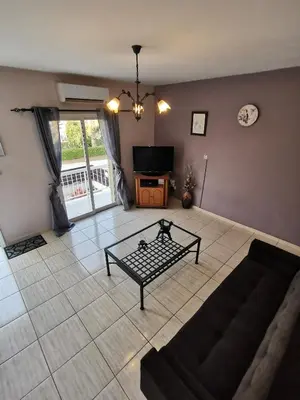 a living room with a couch and a tv at Oroklini Hideaway in Voroklini