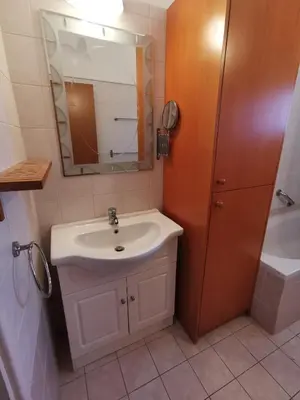 a bathroom with a sink and a mirror and a tub at Oroklini Hideaway in Voroklini