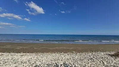 a rocky beach with the ocean in the background at Manors Seaside 2BR House 100m from the Beach & Free Parking in Meneou