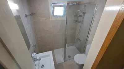 a bathroom with a shower and a toilet at Manors Seaside 2BR House 100m from the Beach & Free Parking in Meneou