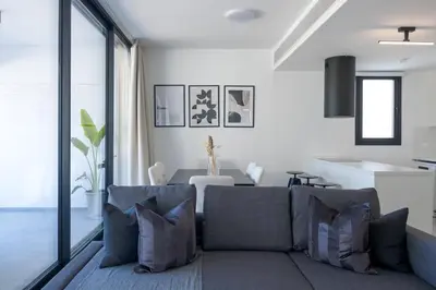 a living room with a couch and a table at Phaedrus Living White Hills Suites Panoramic View in Aglantzia