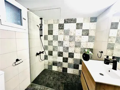 a bathroom with a shower and a sink at MINA 53 in Larnaka