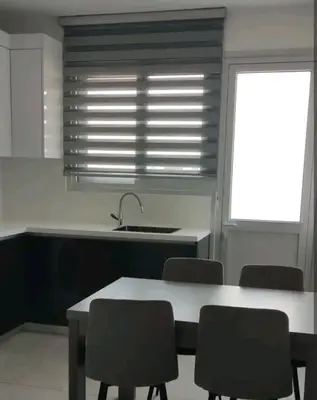 a kitchen with a table and chairs and a sink at Nice flat in Tseri