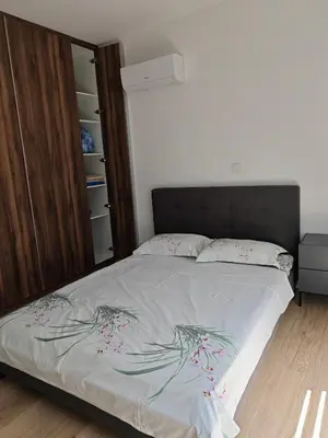 a bedroom with a bed with a bedspread with flowers on it at Nice flat in Tseri