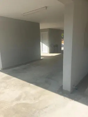 an empty room with white walls and a pillar at Nice flat in Tseri