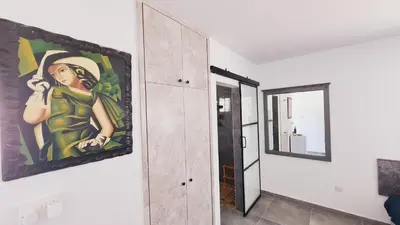 a painting on a wall next to a mirror at Nissi avenue 64 Studio 3 - Luxcyservices in Ayia Napa