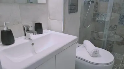 a bathroom with a sink and a toilet and a shower at STAY Napa Aura Apartment in Ayia Napa