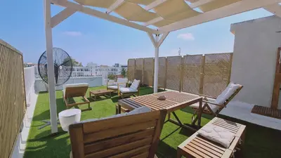 a patio with a table and chairs on a roof at STAY Napa Aura Apartment in Ayia Napa