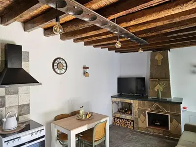 a living room with a table and a fireplace at Jennas House in Arakapas