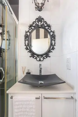 a bathroom with a sink and a mirror on the wall at Happy Tucan in Larnaka
