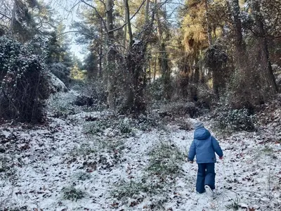 a child walking down a snow covered path at Rifugio Retreat in Kakopetria