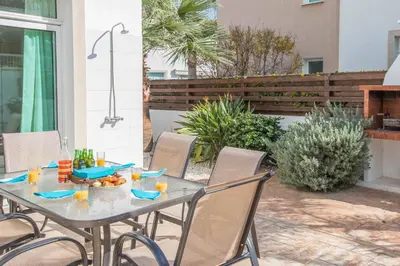 a table with a bowl of food on a patio at Villa Armostia in Protaras