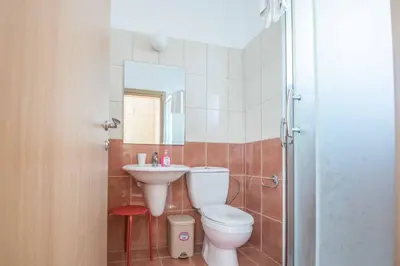 a bathroom with a toilet and a sink at Villa Armostia in Protaras