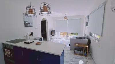 a kitchen with a white counter and a refrigerator at STAY Monte Elias Apartment in Protaras
