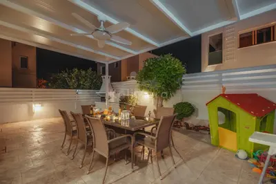 a dining room with a table and chairs and a play house at Villa Maddie in Protaras