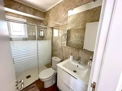 a bathroom with a toilet and a sink and a shower at Sea View Apt - 2 min walk to the Beach & 200 Mbit Highspeed internet in Larnaka