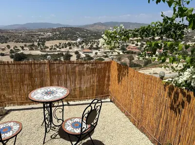 a patio with two chairs and a table with a view at Endless Sunset in Pendakomo