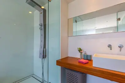 a bathroom with a sink and a shower at Modern seafront apartment in Limassol