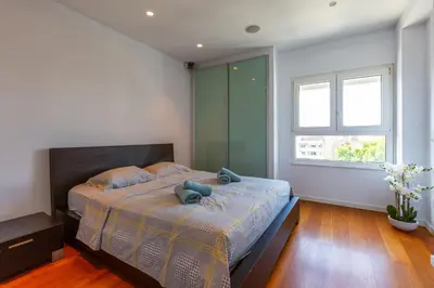 a bedroom with a bed with a teddy bear on it at Modern seafront apartment in Limassol