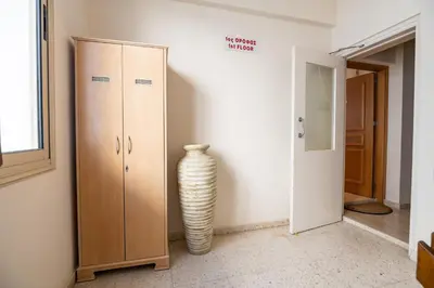 a vase sitting in a room next to a cabinet at Quattro Beachfront Sea View Ap 4 in Larnaka