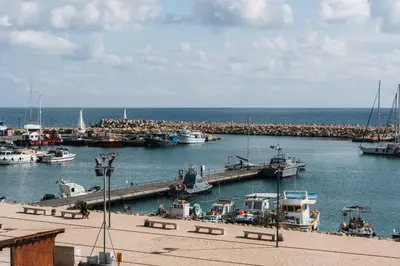 a group of boats are docked at a harbor at Zima Two Seaside in Zygi