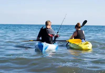 a man and a woman in kayaks in the water at Zima Two Seaside in Zygi