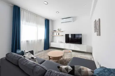 a living room with a couch and a table at Kition City Apartments - Central Location in Larnaka