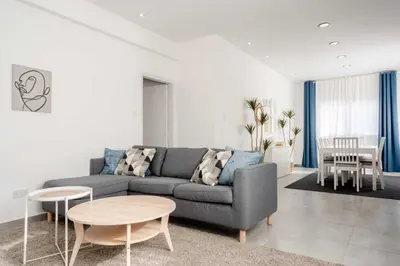 a living room with a couch and a table at Kition City Apartments - Central Location in Larnaka
