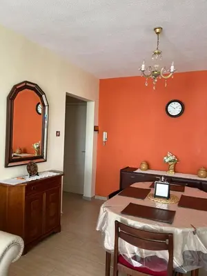 a dining room with a table and a mirror at Beach apartment Mackenzie, Larnaca in Larnaka