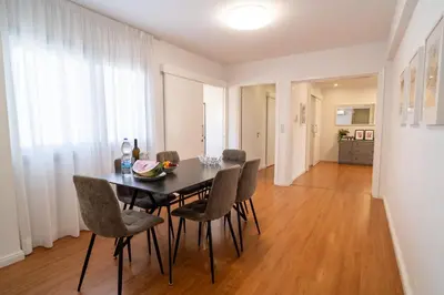 a dining room with a table and chairs at Finikoudes 3 Bedroom Seaview Flat in Larnaka