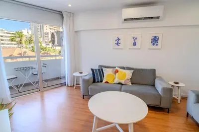 a living room with a couch and a table at Finikoudes 3 Bedroom Seaview Flat in Larnaka