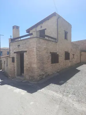an old stone building with a roof at Symela's Nest in Anoyira