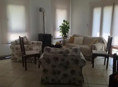 a living room with chairs and a couch and a table at Ta Spitakia tis Theodosias in Kalopanayiotis