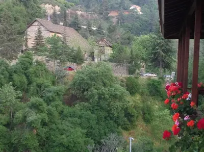a view of a hill with houses and trees at Ta Spitakia tis Theodosias in Kalopanayiotis
