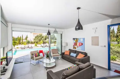 a living room with a couch and a table at Protaras Greco Villa CCV1 in Protaras