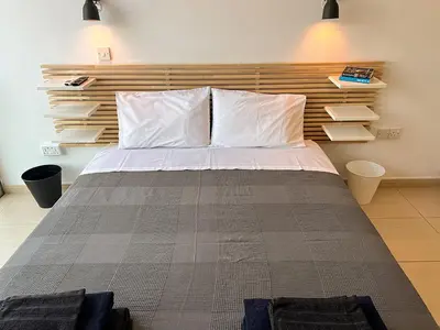 a bedroom with a large bed with white pillows at Number 10 @ Coralli in Protaras